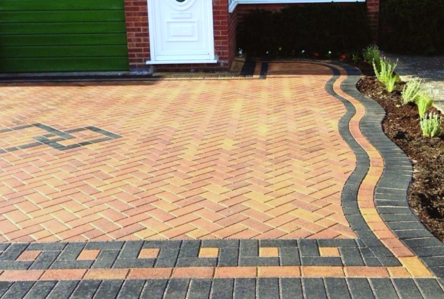 Decorative block paved driveway with curved border