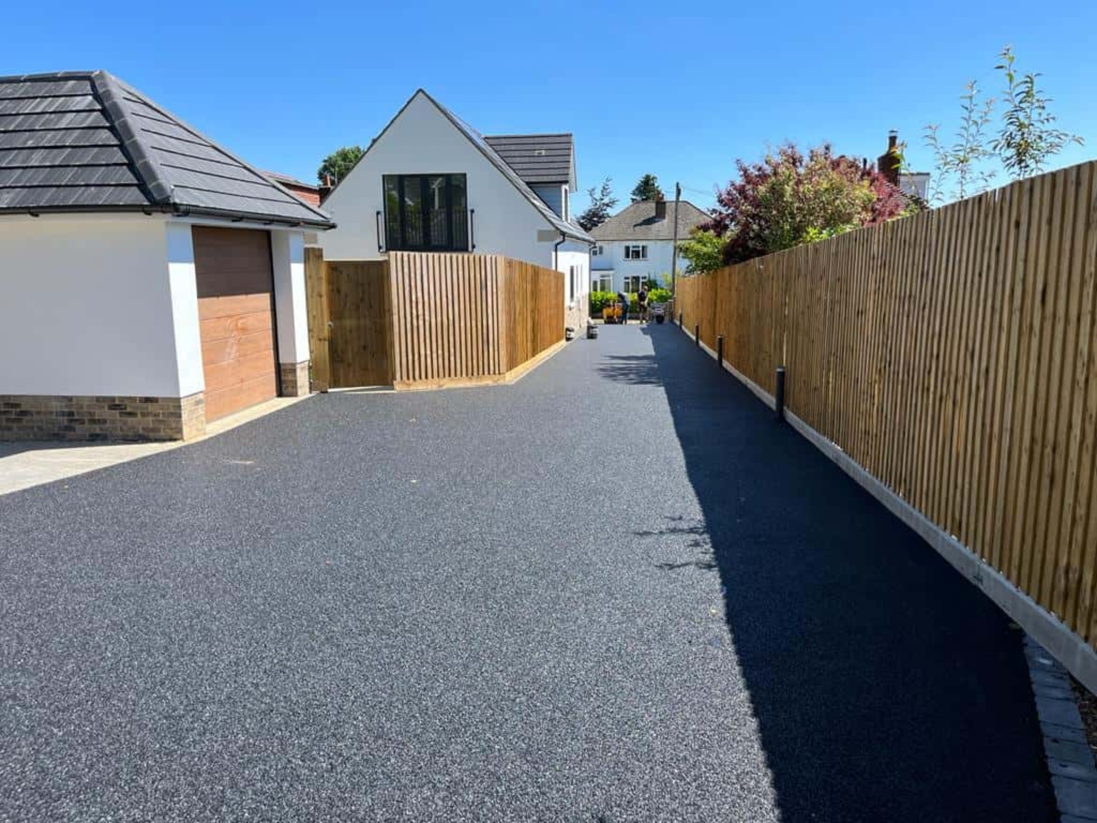 Large tarmac driveway beside modern property